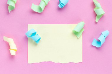 Kutlama kavramı. Renkli parti flamalar ve pembe bir arka plan üzerinde yırtık renkli Not kağıt parçası. Kopya alanı 