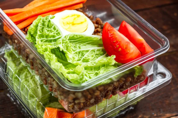 Dietary, healthy meal in a plastic container. Eat right concept. Snack at work, in the office at lunch time, during a break. Lunch box. Healthy food and nutrition concept