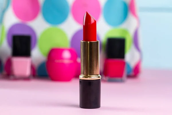 Red lipstick on the background of women's cosmetic bag. Women's cosmetics for professional makeup
