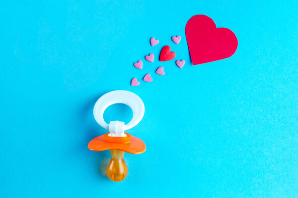 Nipple and hearts on a blue background. Planning the birth of a child. Future motherhood. Waiting for the baby. Planning to become a parent. Pregnancy concept. 