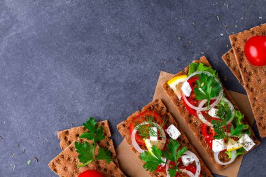 Peynir, domates, marul, soğan, taze maydanoz ve dereotu ile net sandviç. Aperatif ekmek ve fitness yeme. Çavdar ve buğday gevrek ekmek ve pirinç ekmek. Düz yatıyordu, en iyi görünümü 