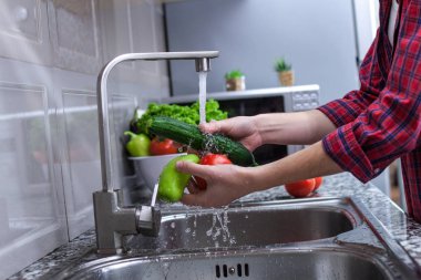 Kadın mutfakta sebze yıkama. Sebze salatası yemek pişirmek için. Doğru ve sağlıklı gıda, doğru beslenme. 