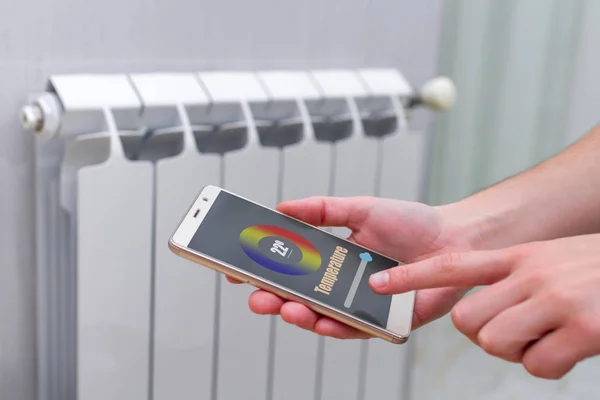 House heating with central heating. Temperature control on the radiator in the apartment on smartphone. Thermostat. Smart home