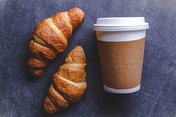 French breakfast with freshly baked croissants and a cup of hot coffee. Top view