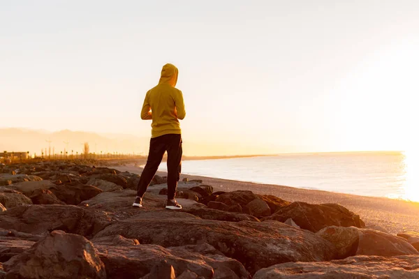 Young Sports Man Hood Standing Rocks Sea Mountains Background Sunset — Stock Photo, Image