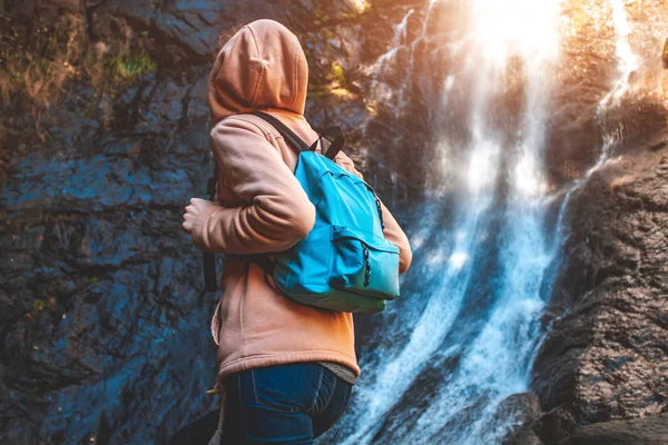 Mujer Joven Viajera Con Una Mochila Azul Eleva Una Cascada — Foto de Stock