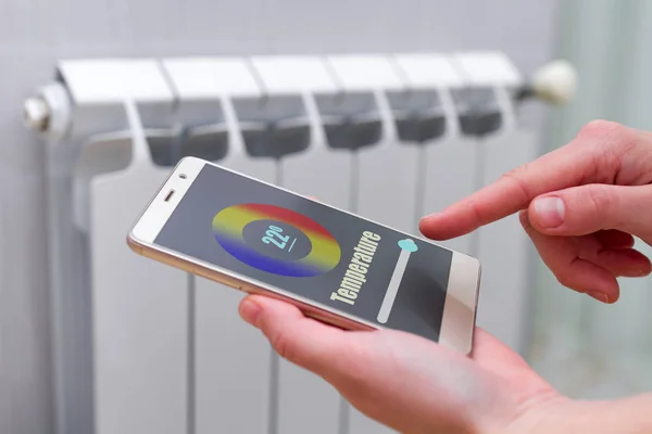 House heating with central heating. Temperature control on the radiator in the apartment on smartphone. Thermostat. Smart home