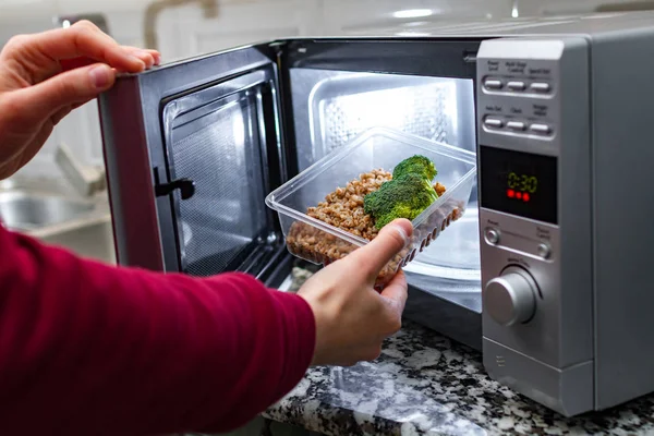 Using Microwave Oven Heat Food Woman Hand Puts Plastic Container — Stock Photo, Image