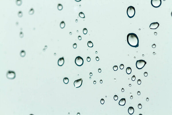 Raindrops texture. Drops on glass during rainy, wet, damp weather