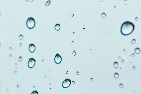 Raindrops texture. Drops on glass during rainy, wet, damp weather