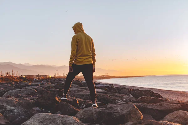 Young Sports Man Hood Taking Step Rocks Sea Mountains Background — Stock Photo, Image