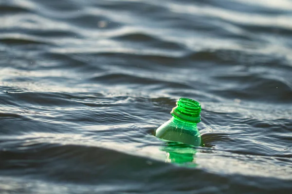 Plastic bottle in the sea. Discharge of plastic waste into the sea. Environmental and water pollution