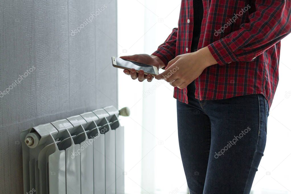 House heating with central heating. Temperature control on the radiator in the apartment on smartphone. Thermostat. Smart home 