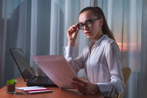 Confused, frustrated business woman having problem with document