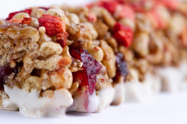 Muesli and Granola bar with fruit and berries close up. Healthy, fitness, sweet dessert snack and fiber food.