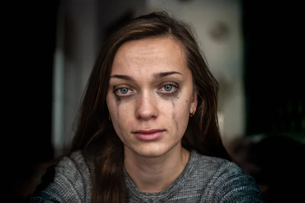 Portrait of a crying, sad, depressed woman because of problems at work and troubles in relationships. Woman violence and depression concept. Social and life problems