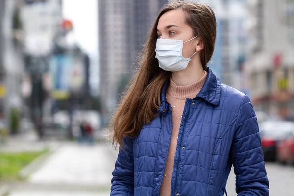 Woman wearing medical mask on street. Protection against virus, 