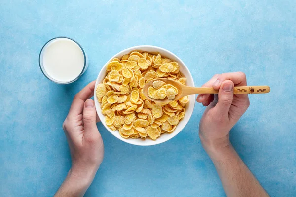 Yellow corn flakes and a glass of milk for dry healthy breakfast