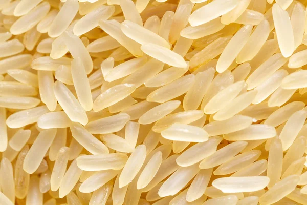 Textuur van droge lange goudgele rijst Stockfoto