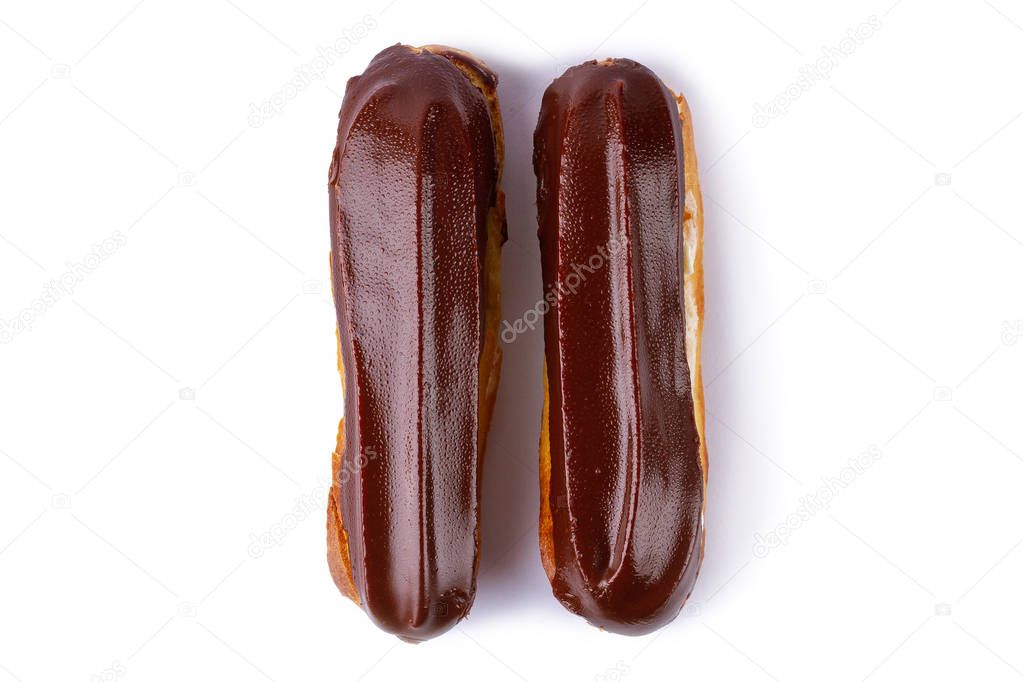 Traditional french dessert. Isolated two eclairs with custard and chocolate icing on white background. Sweet pastry products