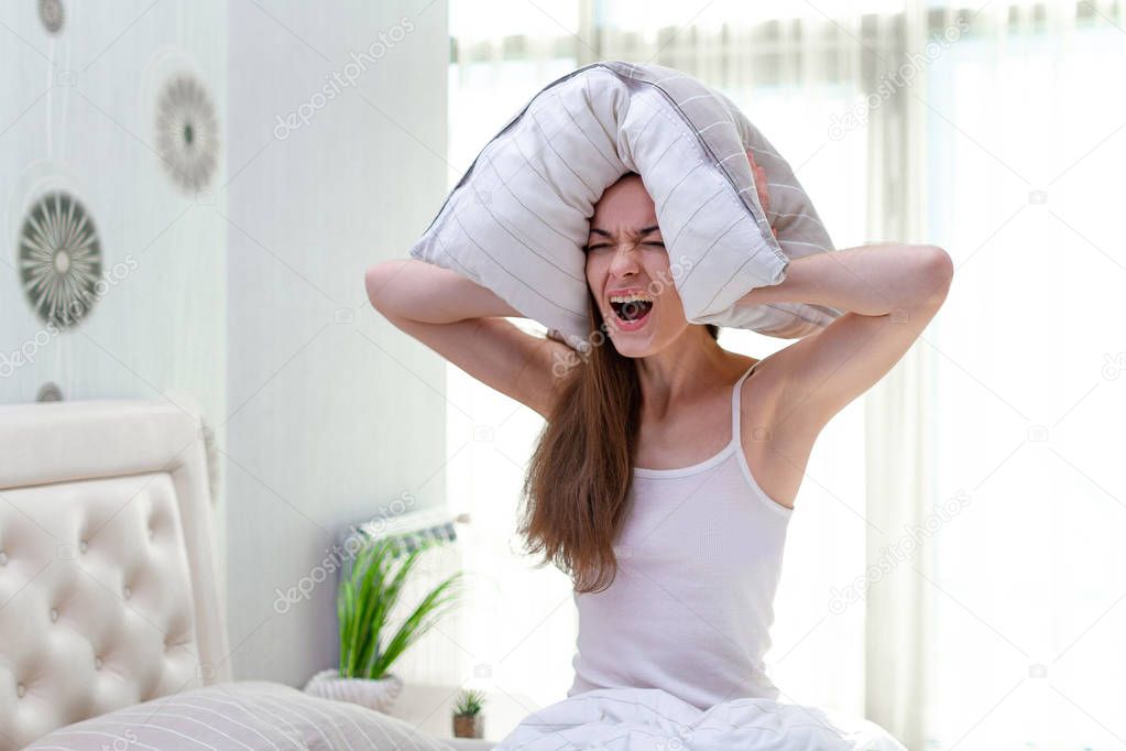 Angry screaming woman suffering and disturbed by noisy neighbors
