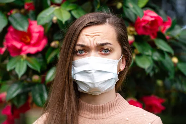 Portrait of allergy woman in medical mask suffering from allergi