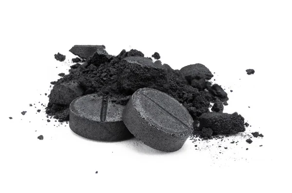 Isolated activated carbon tablets on white background. Natural w — Stock Photo, Image