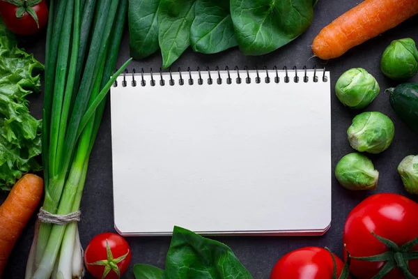 Blank recipe book and ingredients for cooking fresh healthy vegetables dishes. Clean food and balanced diet. Copy space. Control food, diet plan