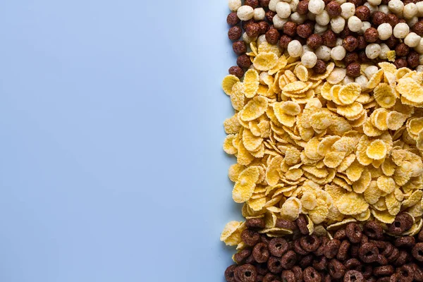 Mix of dry, chocolate balls, rings and yellow corn flakes for ce — Stock Photo, Image