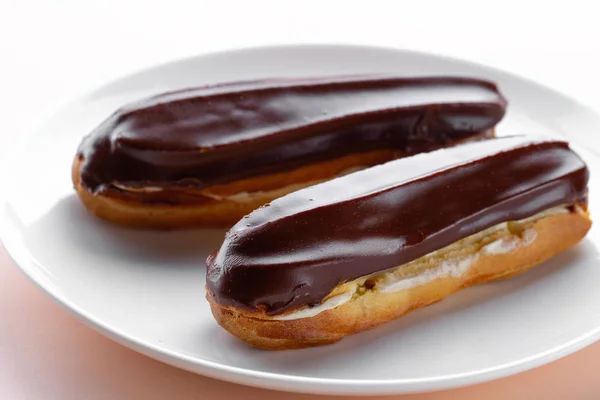 Traditional french dessert. Delicious eclairs with custard and c