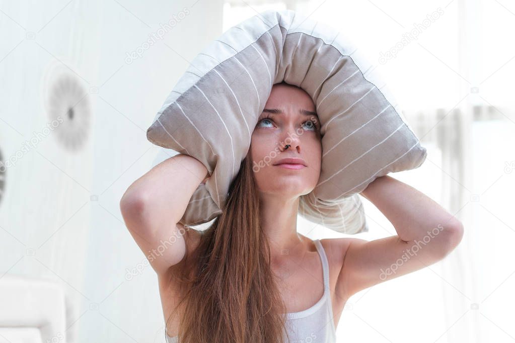 Sad unhappy woman suffering and disturbed by noisy neighbors and