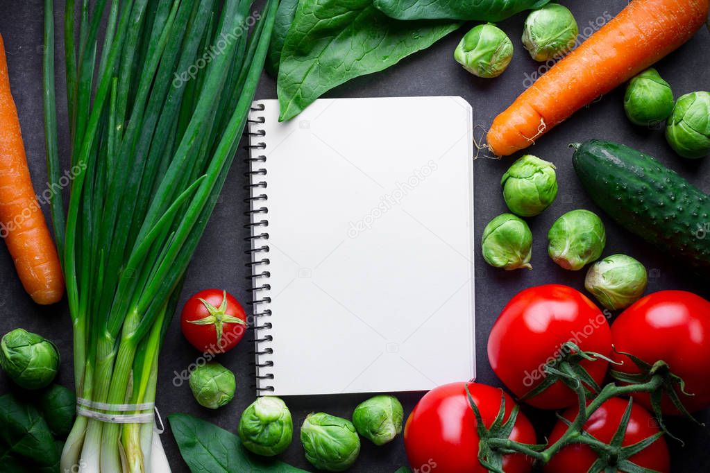 Ripe ingredients and blank recipe book for cooking fresh salad a