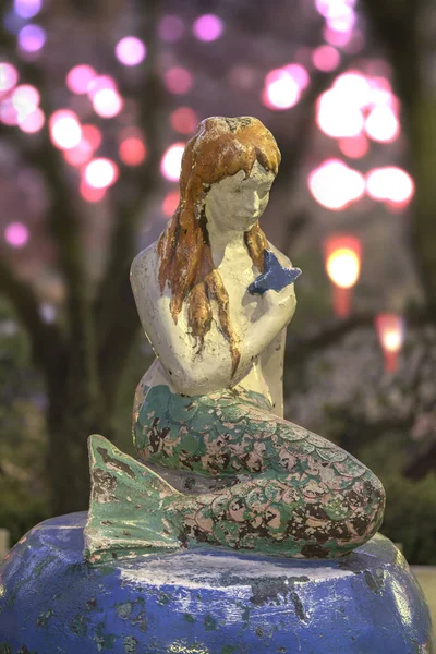 The Little Mermaid from Hans Christian Andersen\'s book under the cherry blossoms of Asukayama Park in the night of Kita district, north of Tokyo.
