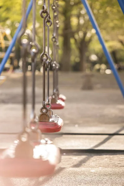 Red swing in the kindergarten of Asukayama park in the Kita district of Tokyo, Japan.