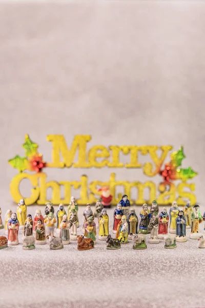 Small figurines of santons from French Provence used like beans of the cake of the kings during the Epiphany also called the Little Christmas with in back a tiny Santa Claus.