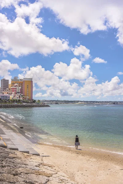 Woman from behind on the Beach in the vicinity of the American Village in Chatan City of Okinawa.