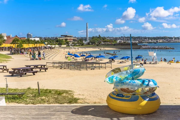 Beach umbrellas and palm trees on the Sunset beach in Chatan City in the American Village of Okinawa island in Japan. — Stock Image Beach Umbrellas Palm Trees Sunset Beach Chatan City American Village Stock Photo