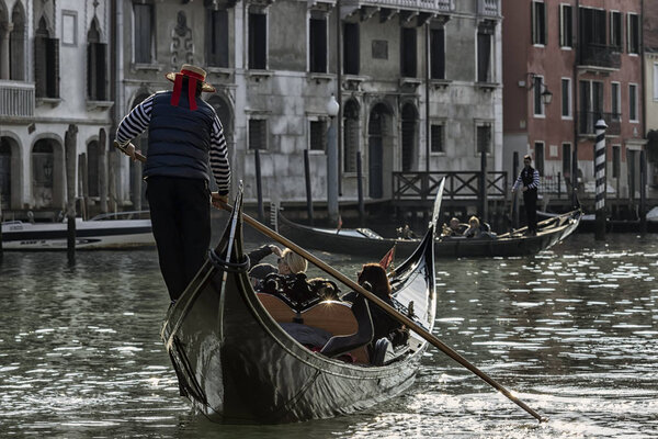 Venice, Italy - 2/21/2016.  Gondolier in canal Grande