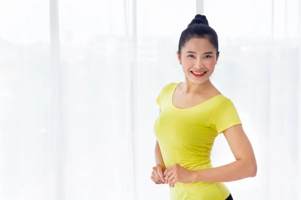 Portrait of Beautiful Asian woman is prepared to exercise yoga in the yoga room for good health and flexibility of the muscles with feel good and happiness. It is a lifestyle activity healthy for everybody