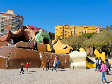 VALENCIA, APRIL 08: Gulliver playground in Turia's gardens with running kids and adults. SPAIN 2018. clipart