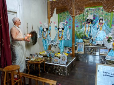 Paris, August 27: The main altar in the Hare Krishna temple called 'ISKCON Radha-Parisisvara', France 2018. The priest offers candles made of refined butter 'ghee'