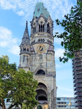 Kaiser Wilhelm Memorial Church, ruin of the imperial church in Berlin, Germany, not rebuilt as a reminder of World War II - and the modern belfry that was added in 1963 clipart