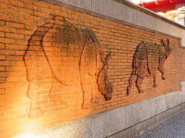 Berlin, Ağustos 09: Zoo, Berlin, Almanya 2017 çevreleyen bir duvar. Batan güneşin ışınları iki gergedanlar antika bir kısma.