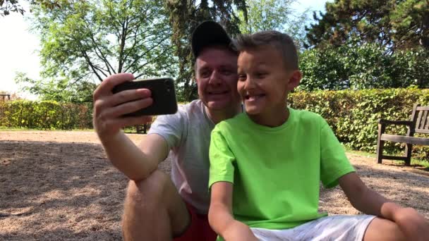 Father Son Taking Selfie Mug Phone Camera Park Summer Day — Stock Video