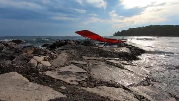 Red Sunchair Stone Coast Stormy Sea Cloudy Blue Sky Green — Stock Video