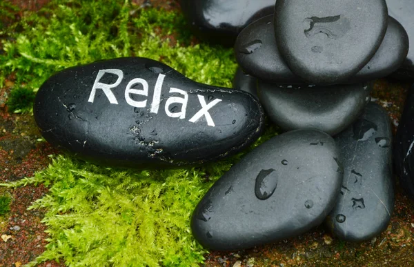 stone with Relax word  on moss