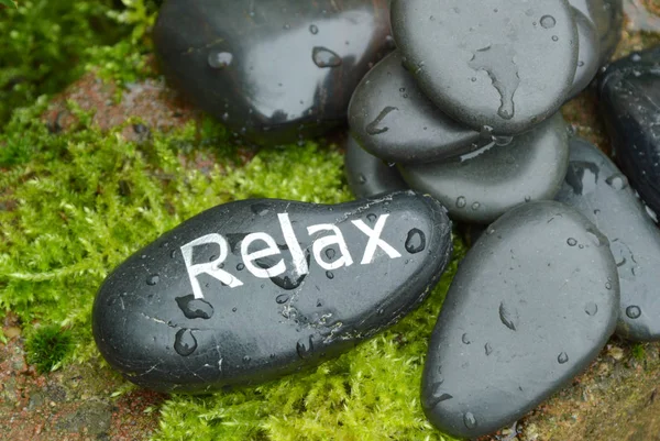 stone with Relax word  on moss