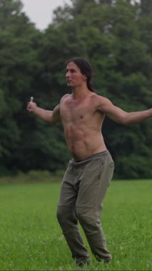 Atletik bir adam, atlama halatı egzersizleri yapıyor. Manzaralı bir yolda, zindelik ve çeviklik sergiliyor. Ağır çekim. Yüksek kalite 4k görüntü