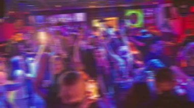 Captivating moments of vibrant nightlife filled with dancing, lights, and energy in a dynamic club setting.