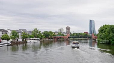Enjoy a peaceful boat ride along the river, presenting stunning buildings and vibrant lush greenery all around. Frankfurt am Main. Germany. 03 08 2025. High quality 4k footage